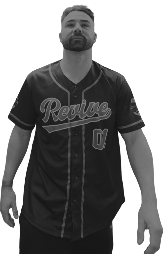 Man wearing a black Revive Men's Hair Clinic branded baseball jersey