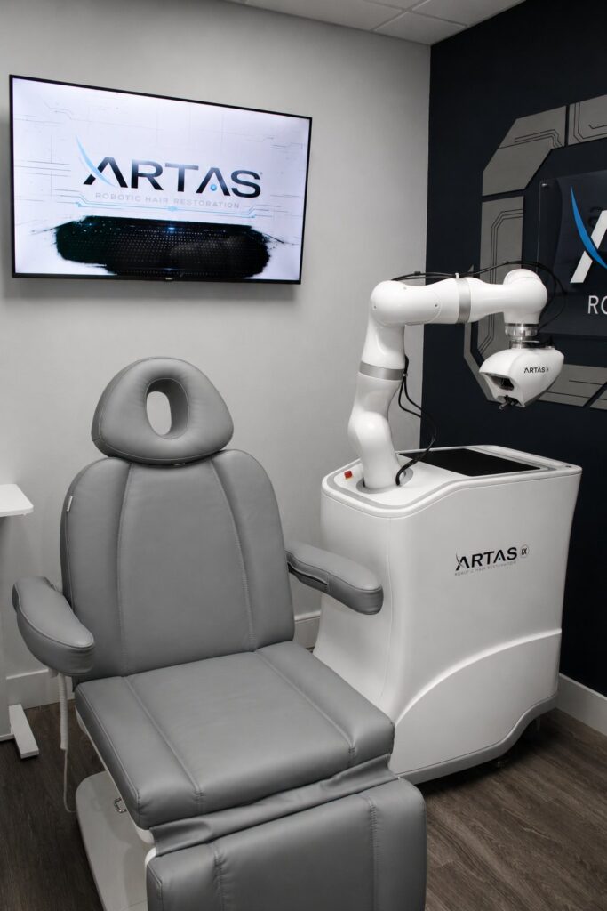 ARTAS iX robotic system beside the treatment chair in the ARTAS room at Revive Mens Hair Clinic